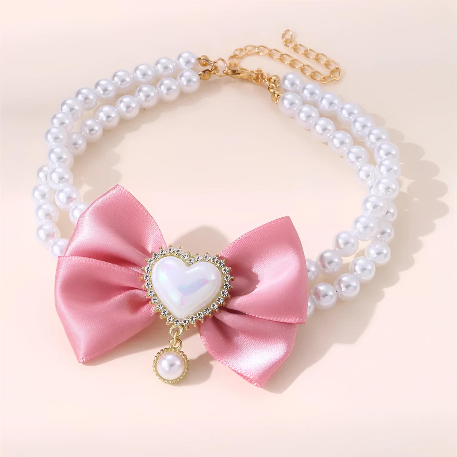 Cute heart shape princess style pet necklace with pearl beads on pink background