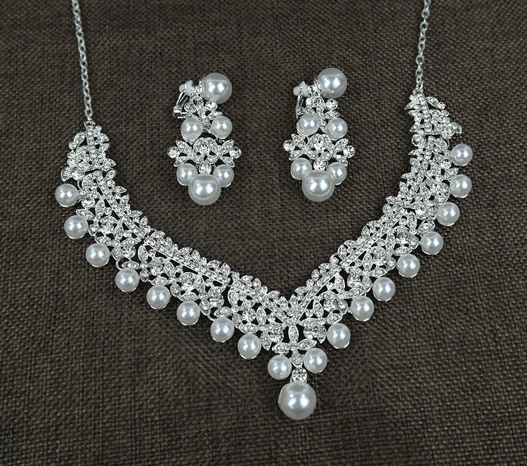 White pearl and crystal bridal set with necklace, earrings, and hair accessory on display