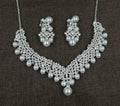 White pearl and crystal bridal set with necklace, earrings, and hair accessory on display