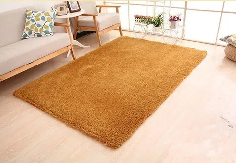 Solid colour plush carpet with soft surface and rectangular shape on hardwood floor