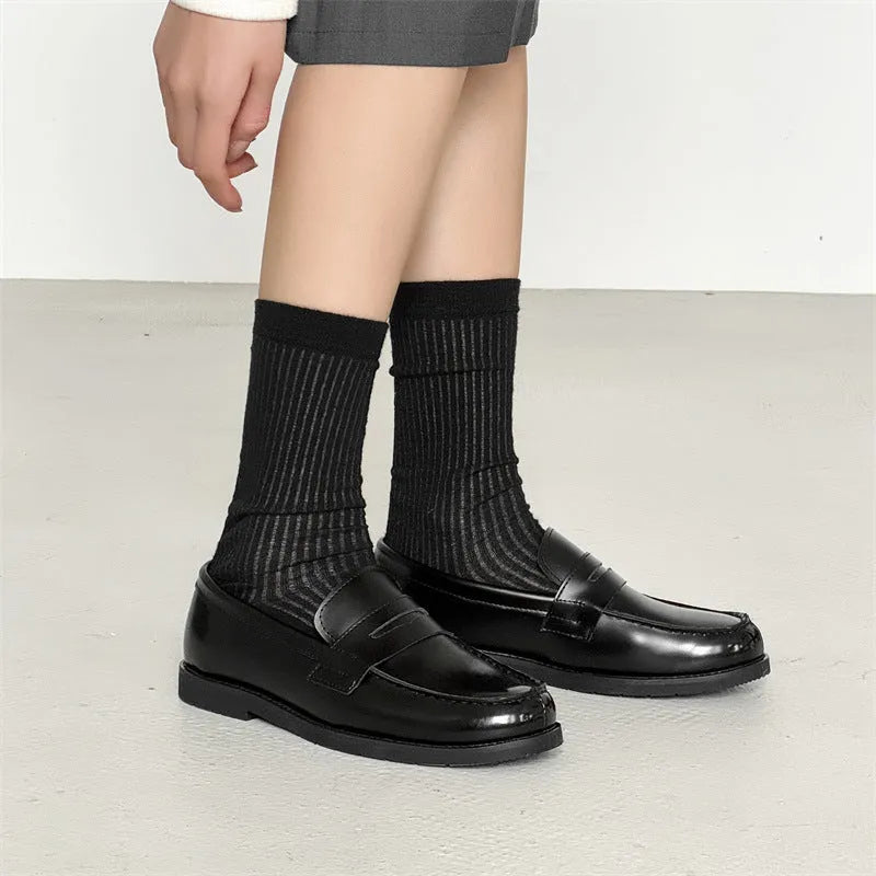 Black men's classic slip-on derby leather shoes with a rubber sole, shown in a mature style.