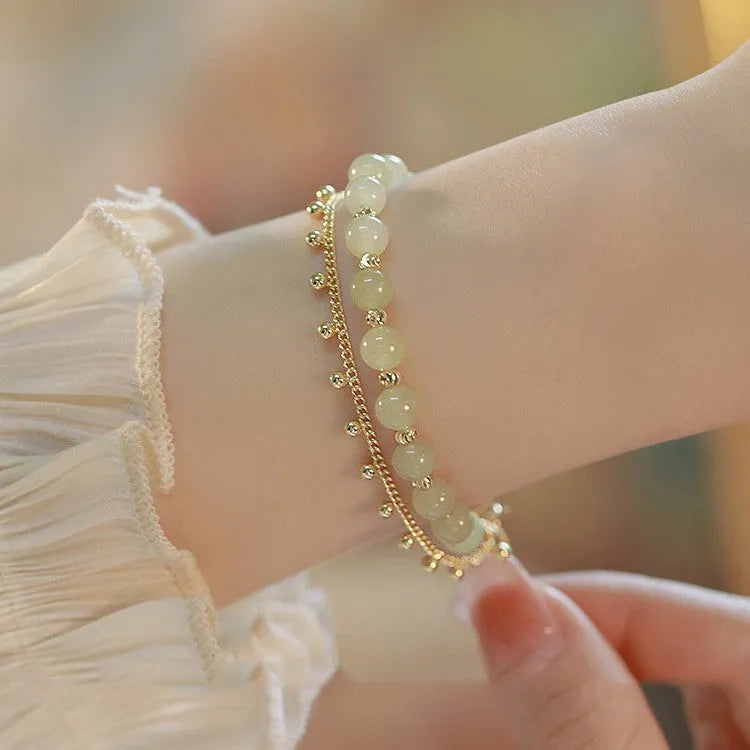 Hetian Jade bracelet with princess running beaded style on neutral background