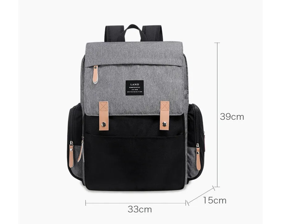 Land Mommy large oxford cloth diaper backpack in grey with a changing mat, shown open.