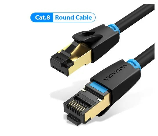 Flat and round styles of a black Cat8 shielded Ethernet cable with RJ45 plugs on a wood desk.