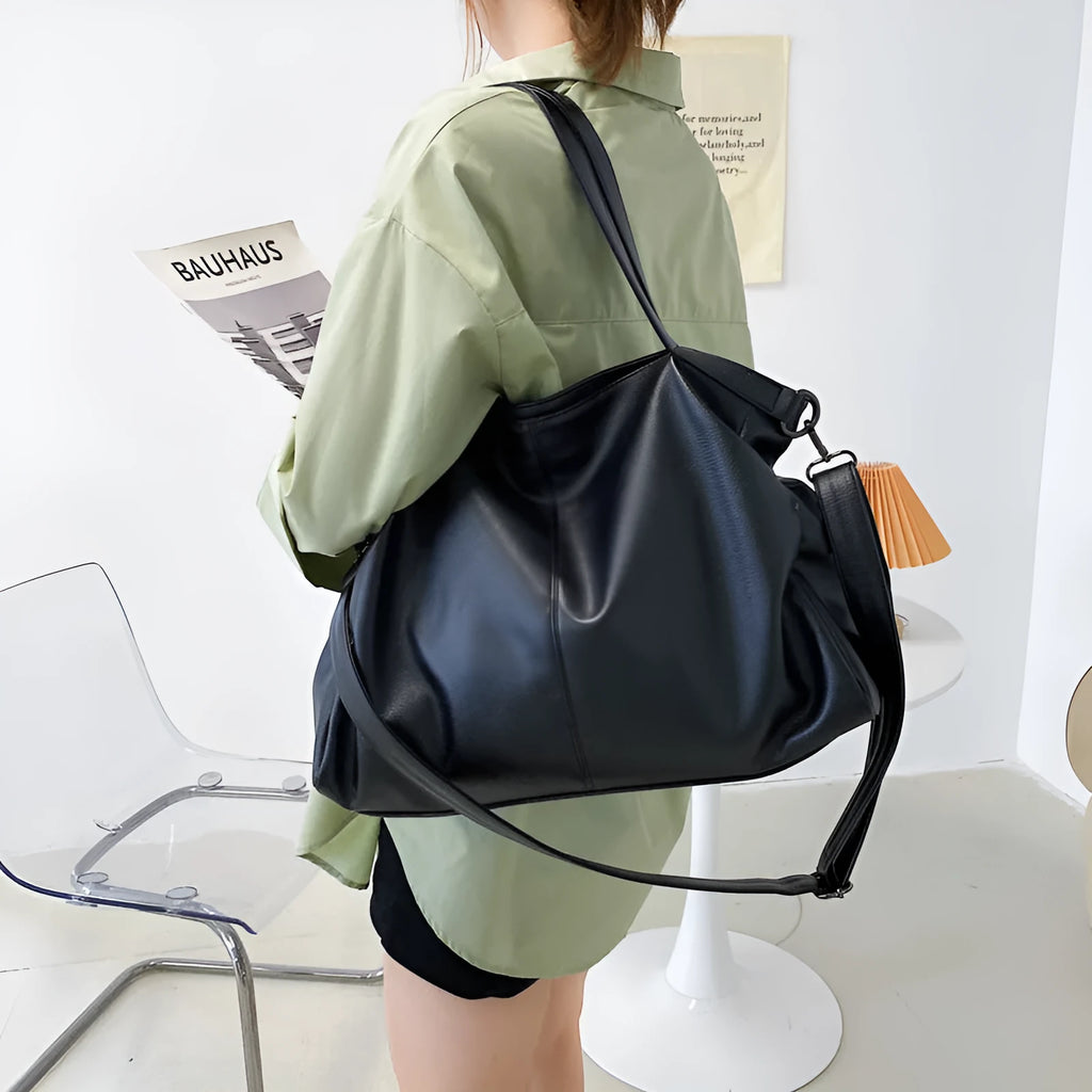 Soft surface messenger shoulder bag in horizontal square shape with zipper opening and internal compartments