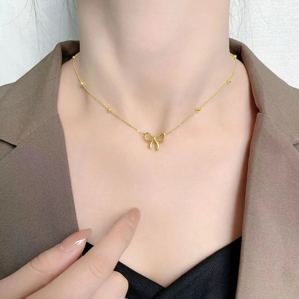 Gold bow necklace with adjustable chain on titanium steel with electroplated finish