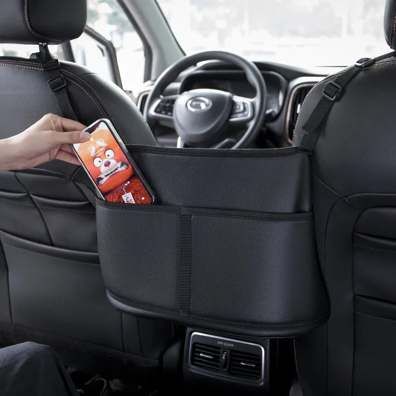 Black leather car seat net pocket storage bag with carbon fiber pattern, 38x24x15cm, placed on a car seat