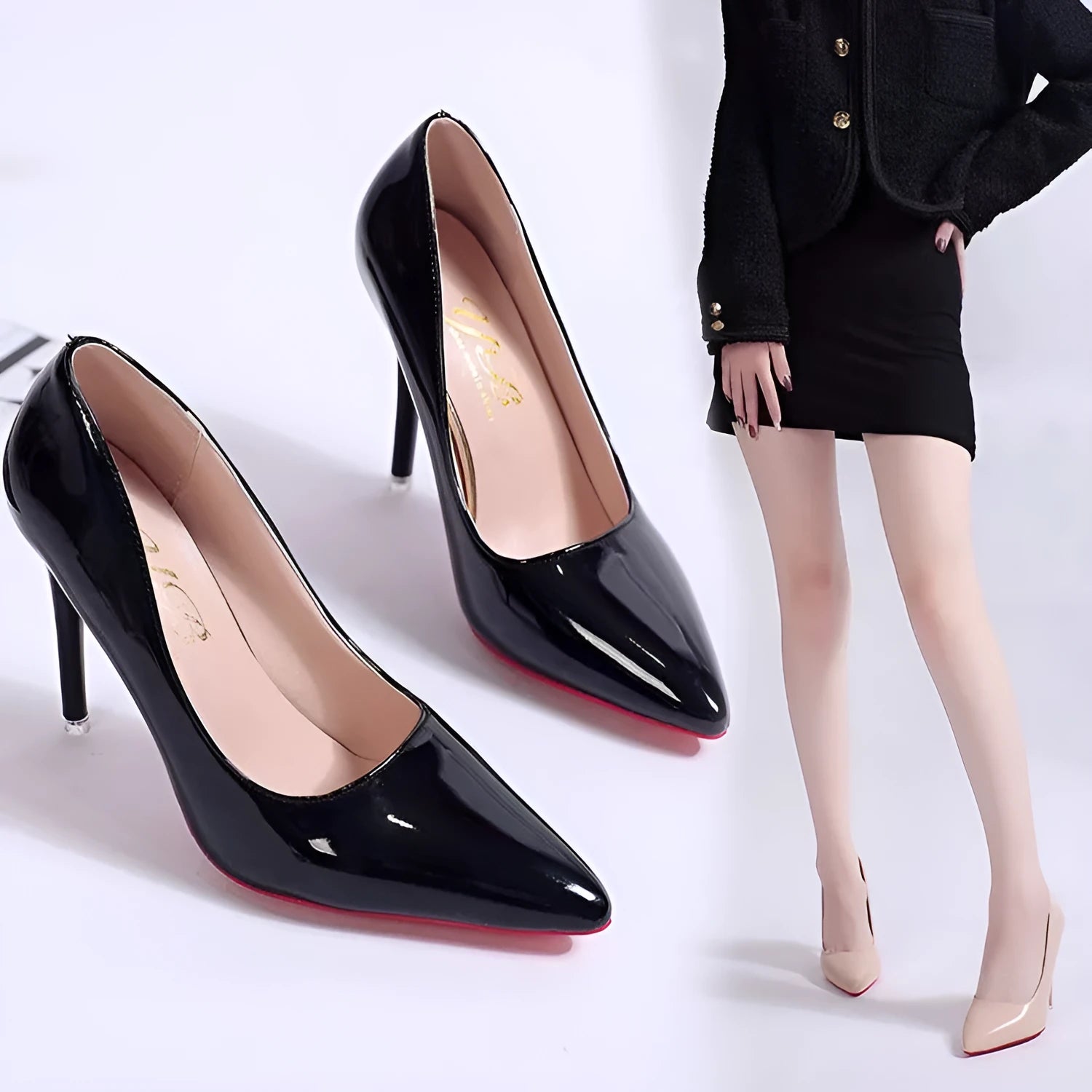 Women's black stiletto heel pump with pointed toe and shallow mouth opening on a white background.