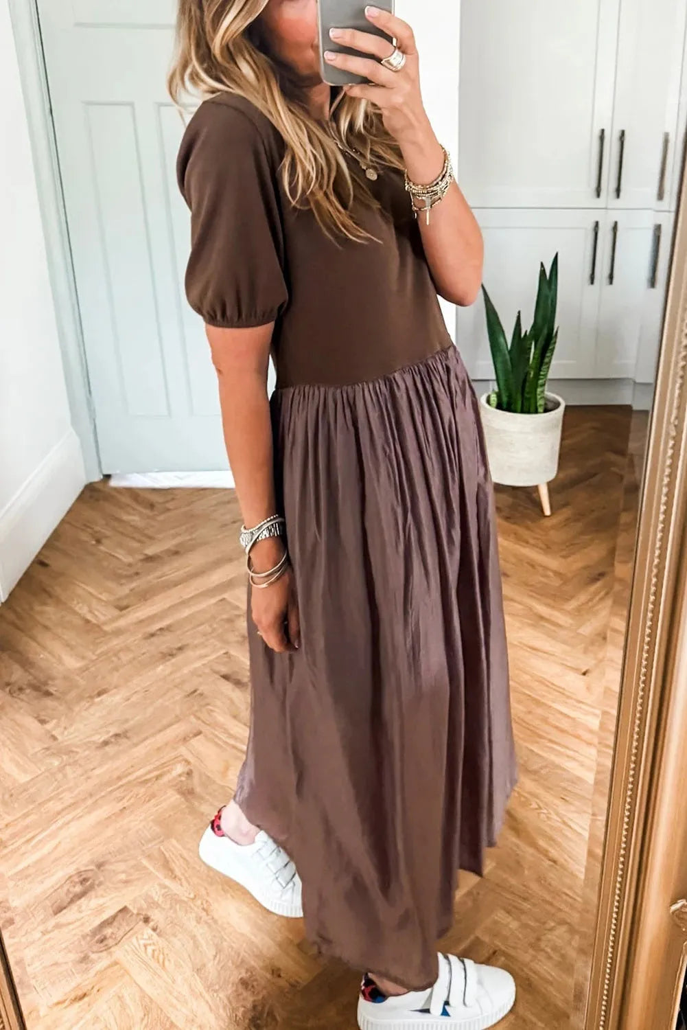 Woman wearing a coffee-coloured knitted patchwork dress with high waist and short sleeves