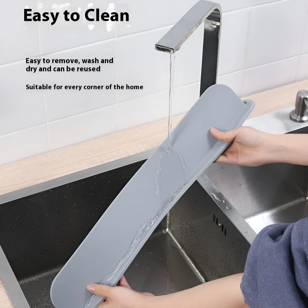 Black silicone kitchen sink water blocking plate measuring 52x5x85mm placed around faucet base