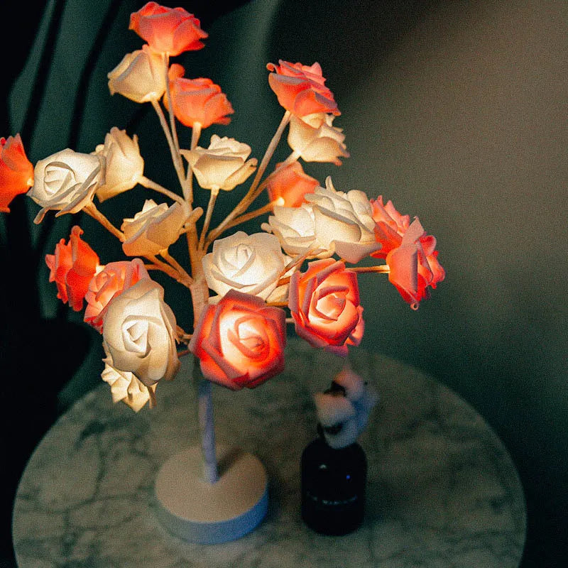 White and red rose flower LED table lamp with bonsai tree lights on a table.
