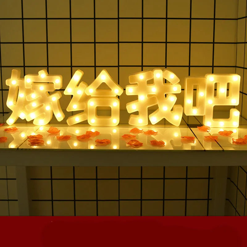 Plastic LED letter light decoration spelling a message, 22cm in height.
