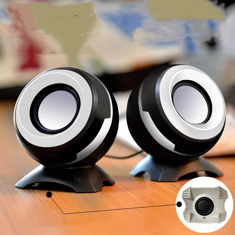 Compact black and gold desktop computer speakers with USB cable