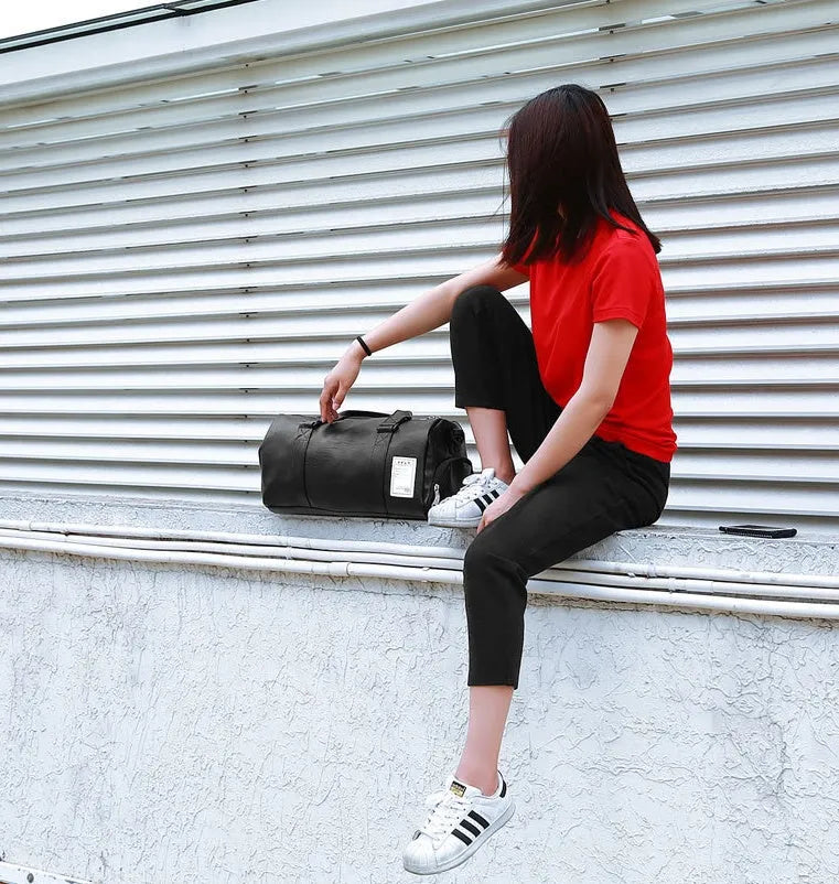 Black waterproof sports fitness bag with separate shoe compartments and diagonal carrying straps