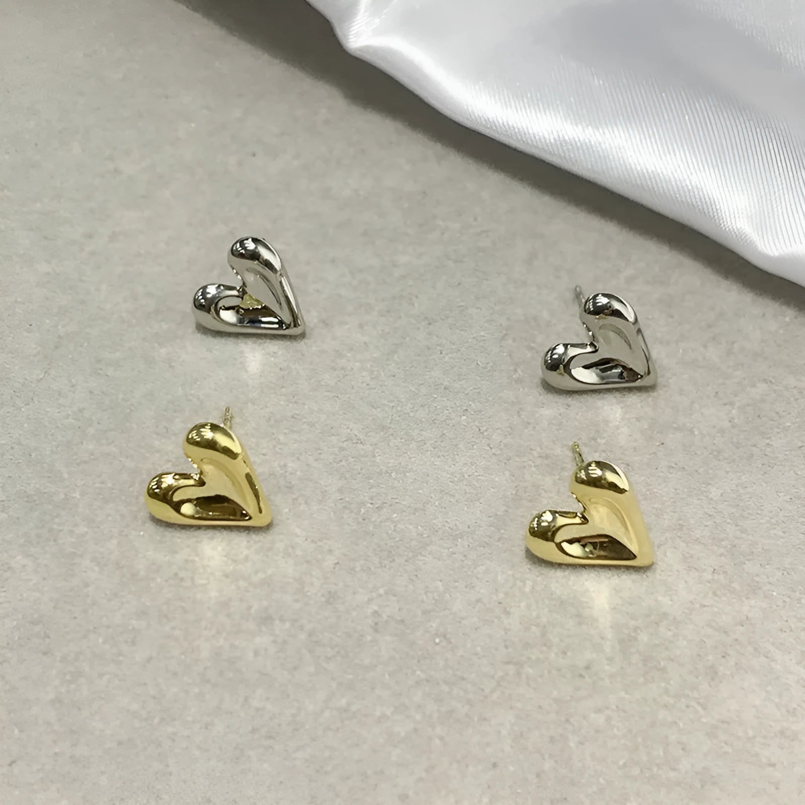 Simple heart-shaped metal drop earrings in gold and silvery colour options