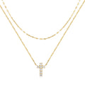 Sterling silver double layer cross pendant necklace with a clavicle chain in a gold tone finish.