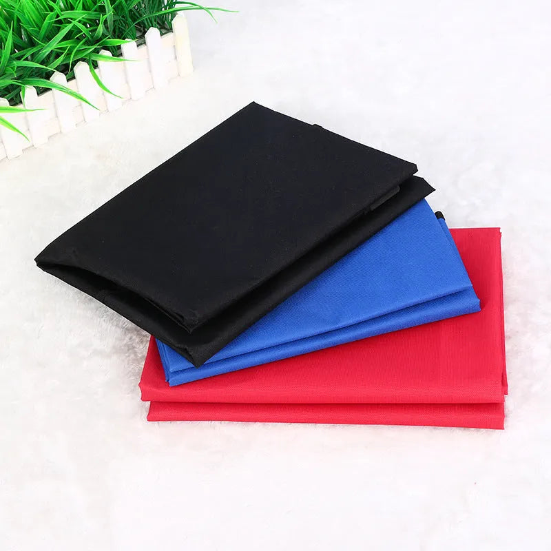 A square black car pet pad for dogs and cats on a vehicle seat.