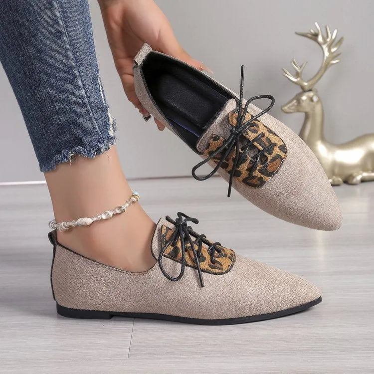 Beige leopard print women's pointed toe pumps on a white background.