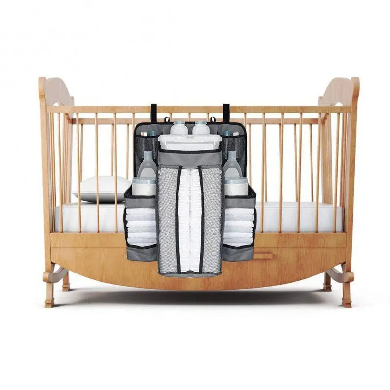 Gray baby diaper organizer hanging on crib with adjustable Velcro straps, TC Oxford cloth construction