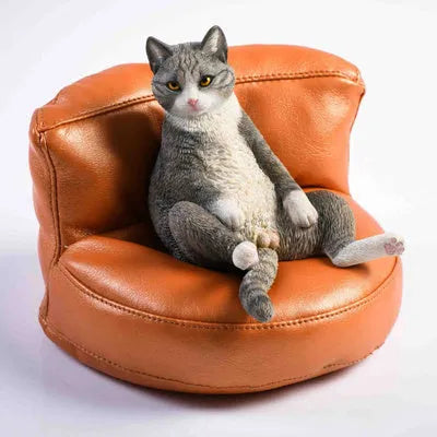 Small lazy cat model resting on a sofa, a resin car dashboard ornament decoration.