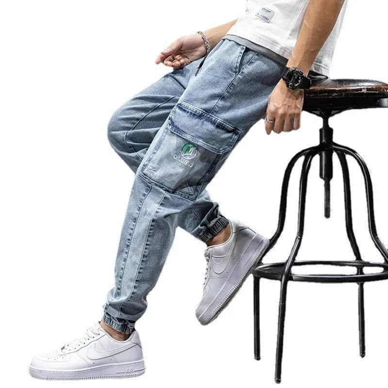 Men's loose straight-leg cargo casual jeans in blue, showing cargo pockets and mid-waist fit.