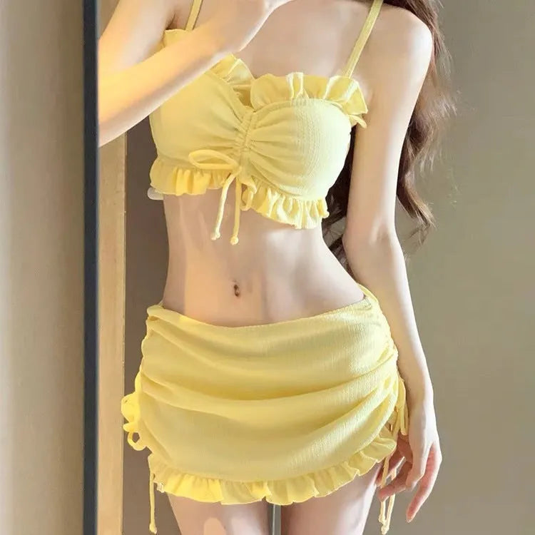 Women's split bikini swimsuit in Milk Silk fabric, shown in pitaya red, yellow, and black colour options.