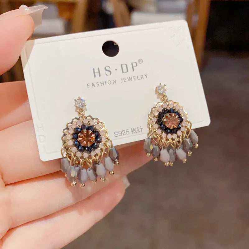 Geometric crystal tassel earrings with thick gold plating and embedded diamond crystals