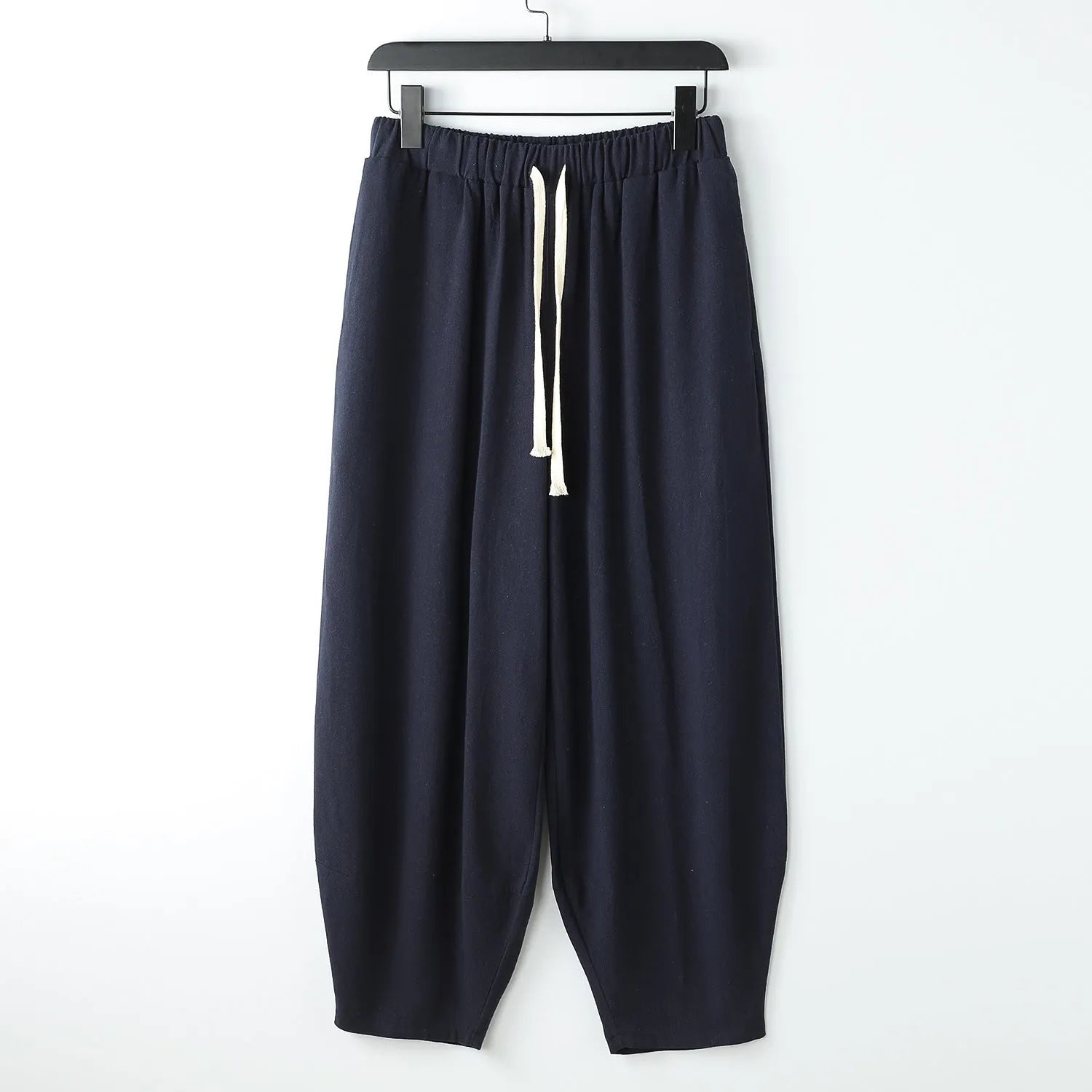 Men's linen harem pants with ankle ties in tapered loose fit on larger model