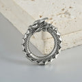 Large hollow out stainless steel earrings with an antique silver dragon design.