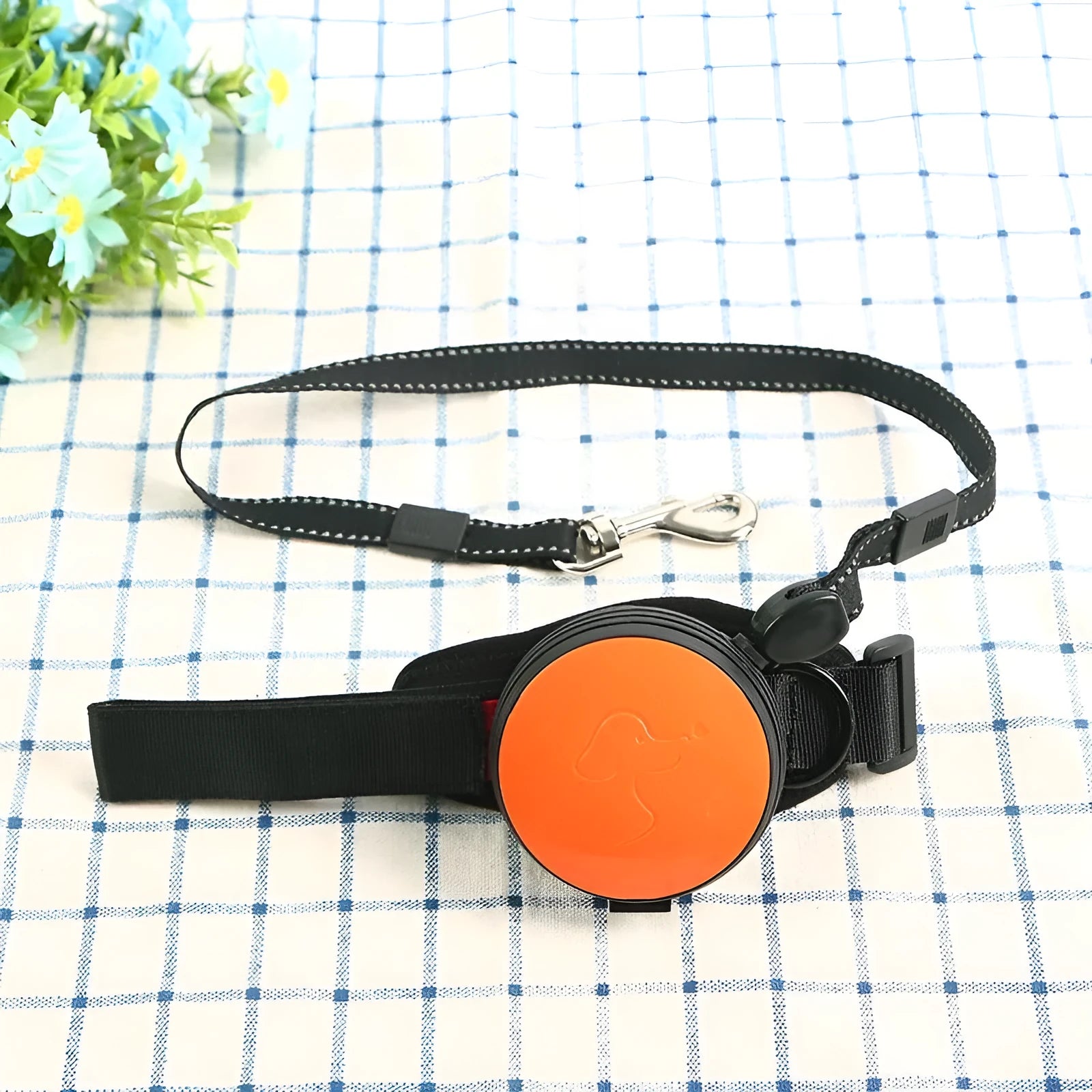 Retractable dog leash extended to 3 metres with explosion-proof mechanism in vibrant orange colour