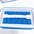 Blue silicone ice cube tray with 36 square cavities and a lid on a wooden table