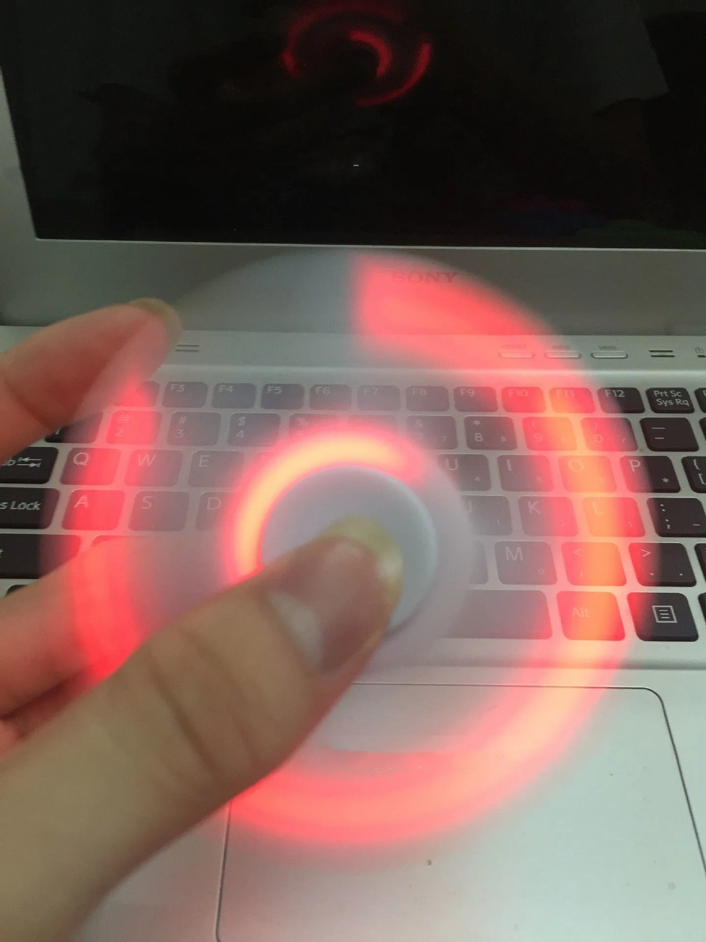 Compact white Bluetooth speaker and MP3 player designed as a fidget spinner toy.