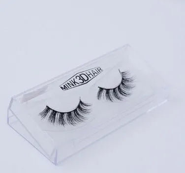 Pair of faux mink eyelashes with long tail and cotton stem against white background