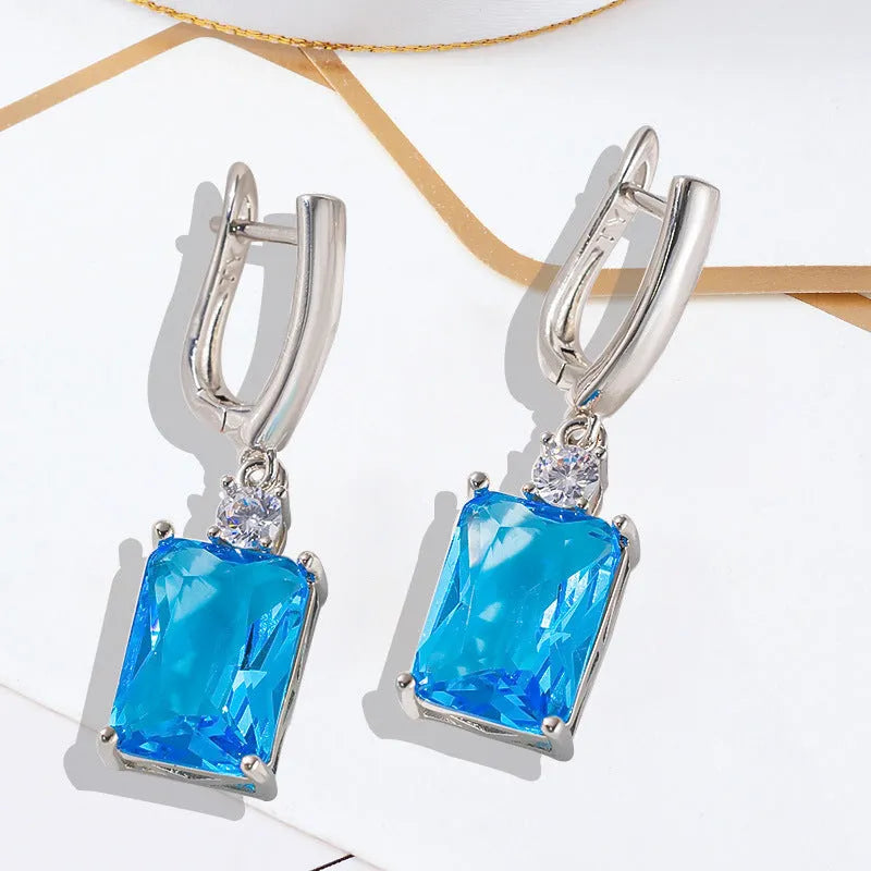 Square copper earrings with electroplated gold or silver finish and quadrilateral geometry
