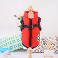 Waterproof dog coat with harness in red, navy blue, and army green on a winter background
