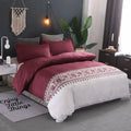 Plain weave polyester duvet cover set in solid colour or floral pattern on a bed