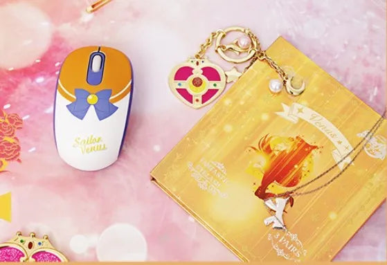 Pink Sailor Moon cartoon wireless mouse with USB receiver on a desk