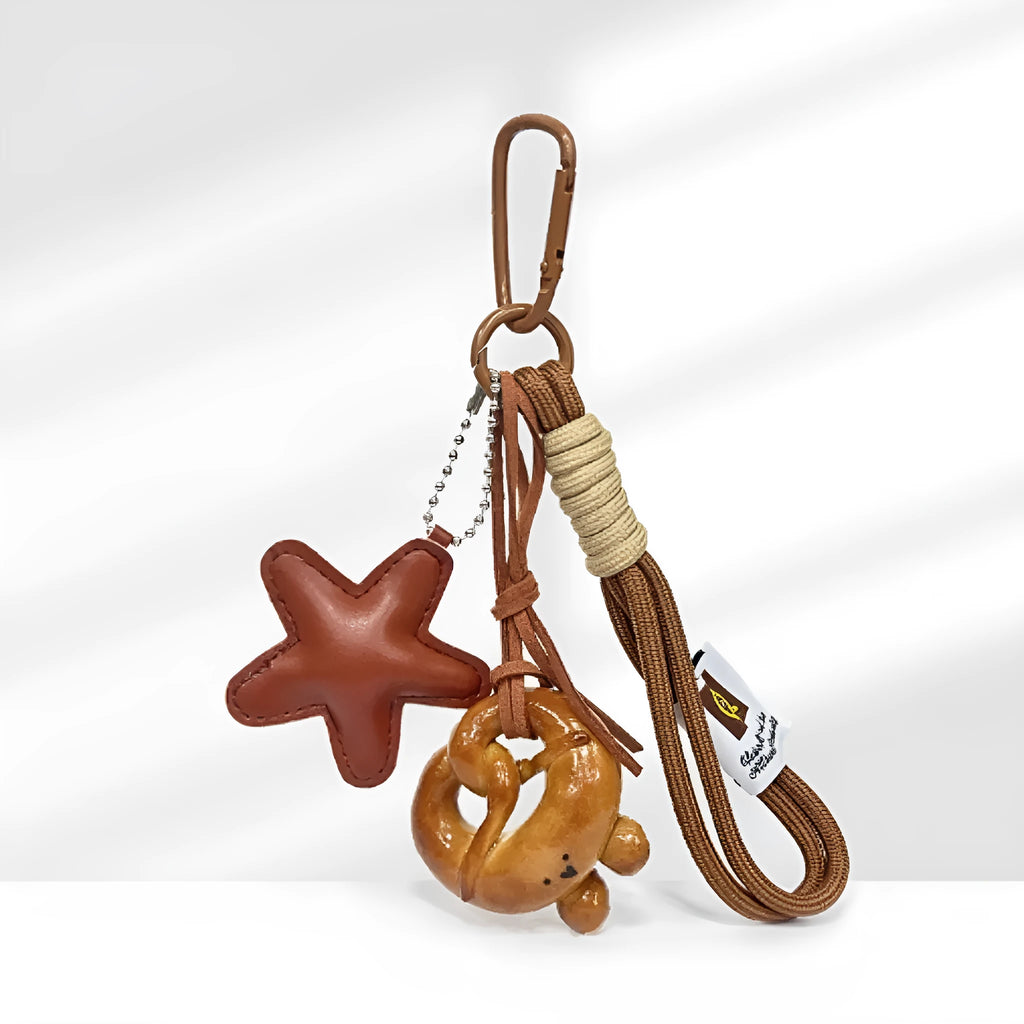 Handmade resin soda bread handbag pendant with baking varnish finish and brown carrying strap.