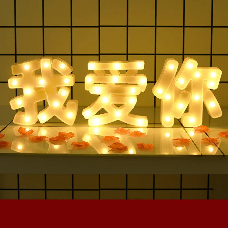 Plastic LED letter light decoration spelling a message, 22cm in height.
