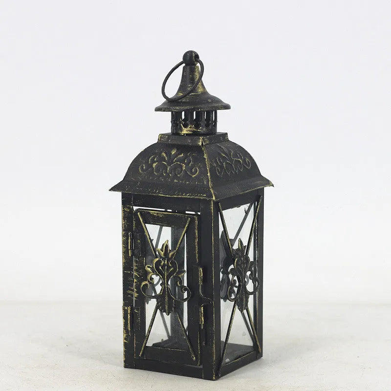 European wrought iron storm lantern with tempered glass in black or white gold finish, shown in small, medium, and large sizes.