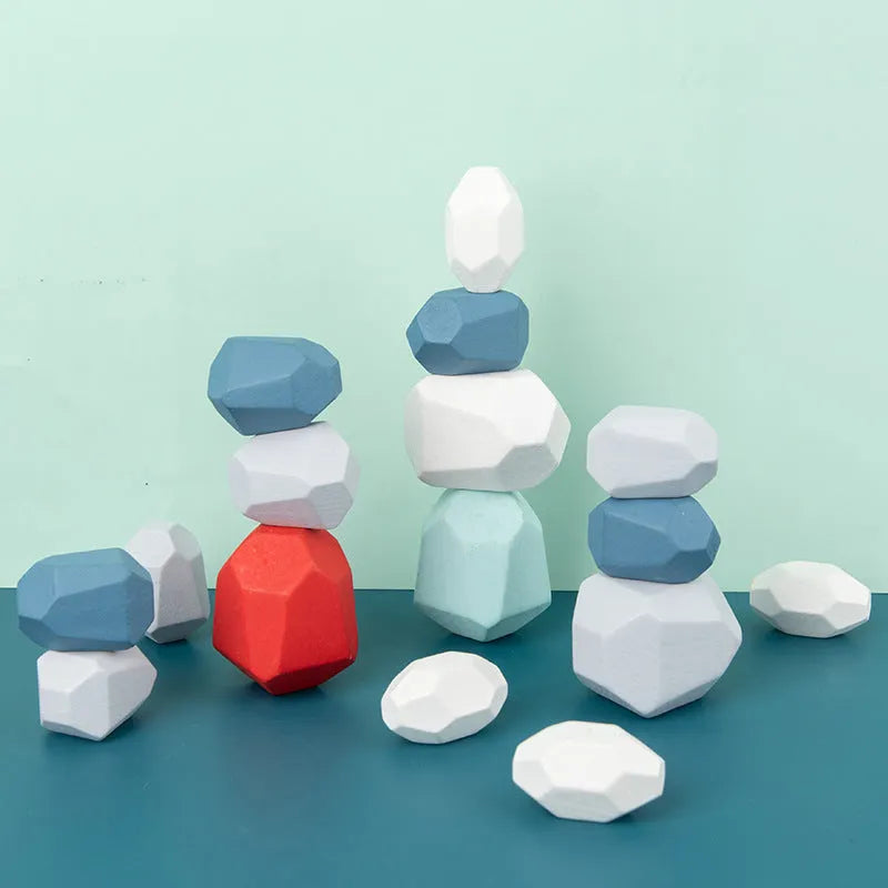 Wooden building block set with coloured and natural stone stacks on a table, suitable for children aged 4-6
