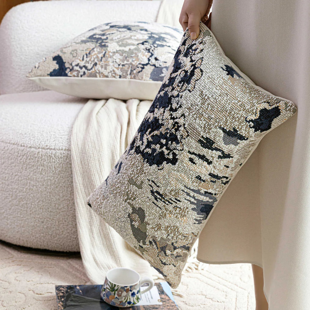 Antique blue wool-blended square throw pillow with abstract floral pattern on a neutral sofa