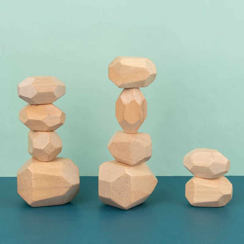 Wooden building block set with coloured and natural stone stacks on a table, suitable for children aged 4-6