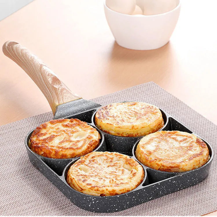 Non-stick egg dumpling frying pan in black aluminium with two holes for cooking breakfast burgers