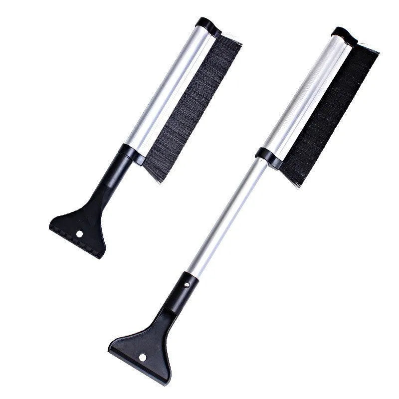 Silver retractable aluminum alloy car snow shovel extended to 65cm on a vehicle windscreen