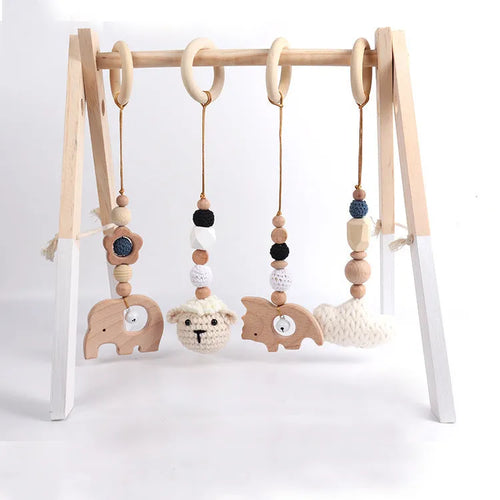 Beech wood baby rattle with animal pendants in orange, 28cm length, on white background