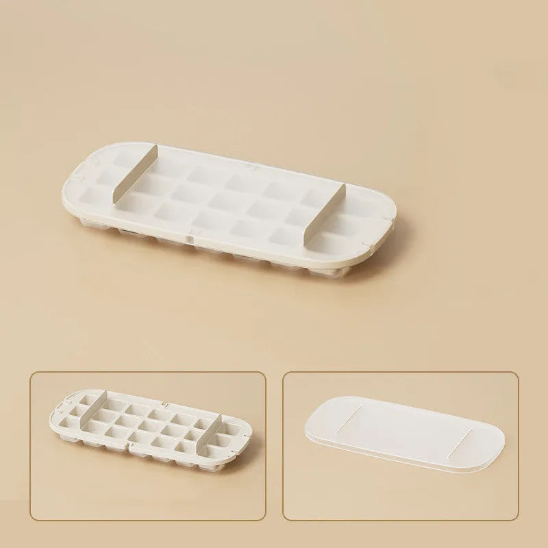 Yellow lever-action ice cube tray with high-capacity grid and attached ice shovel on a blue background.