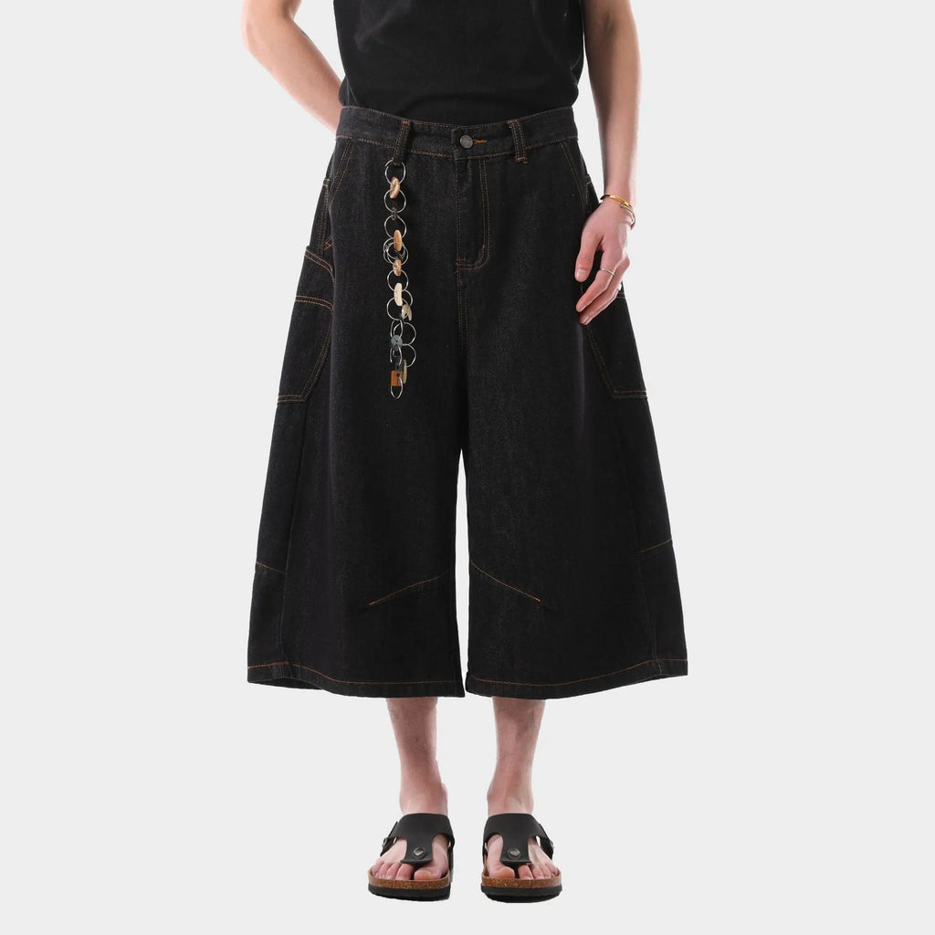 Man wearing black retro washed straight-leg denim cropped pants with side pockets.