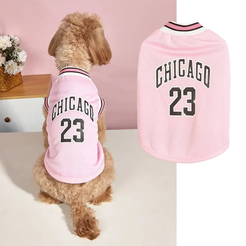 Dog wearing a black mesh polyester basketball vest with number 23 print, side view