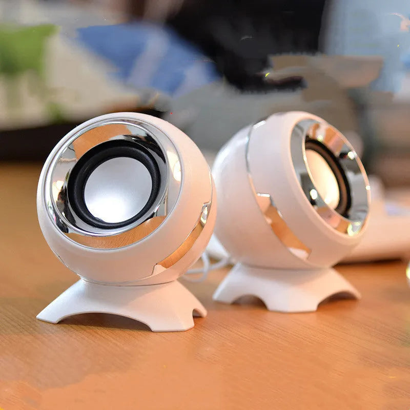 Compact black and gold desktop computer speakers with USB cable